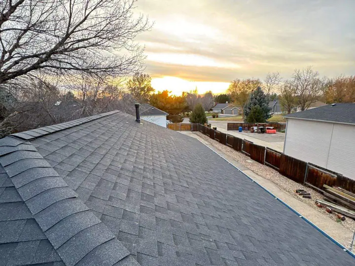 Completed architectural shingle roof at sunset