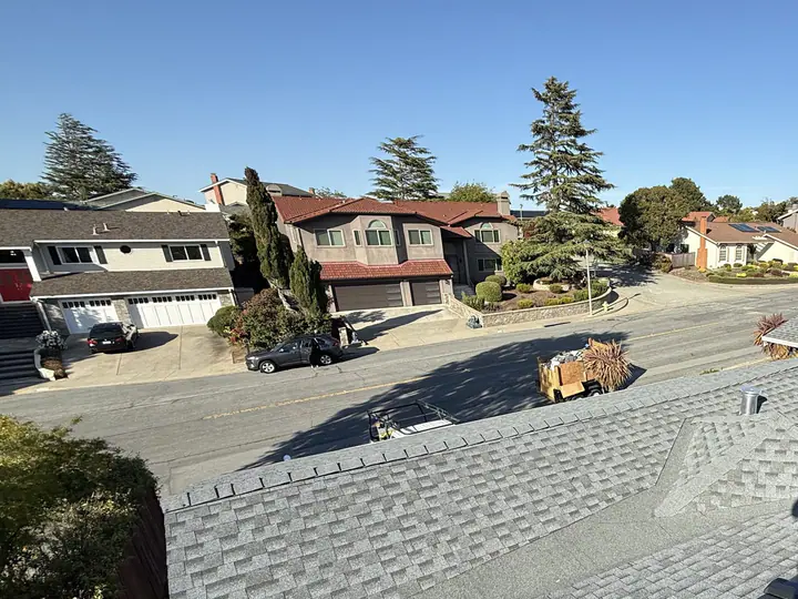 Finished shingle roof with solar panels in a Bay Area neighborhood