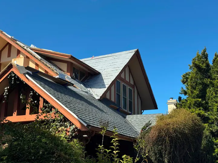 Tudor-style home mid re-roof, new underlayment and shingles going on